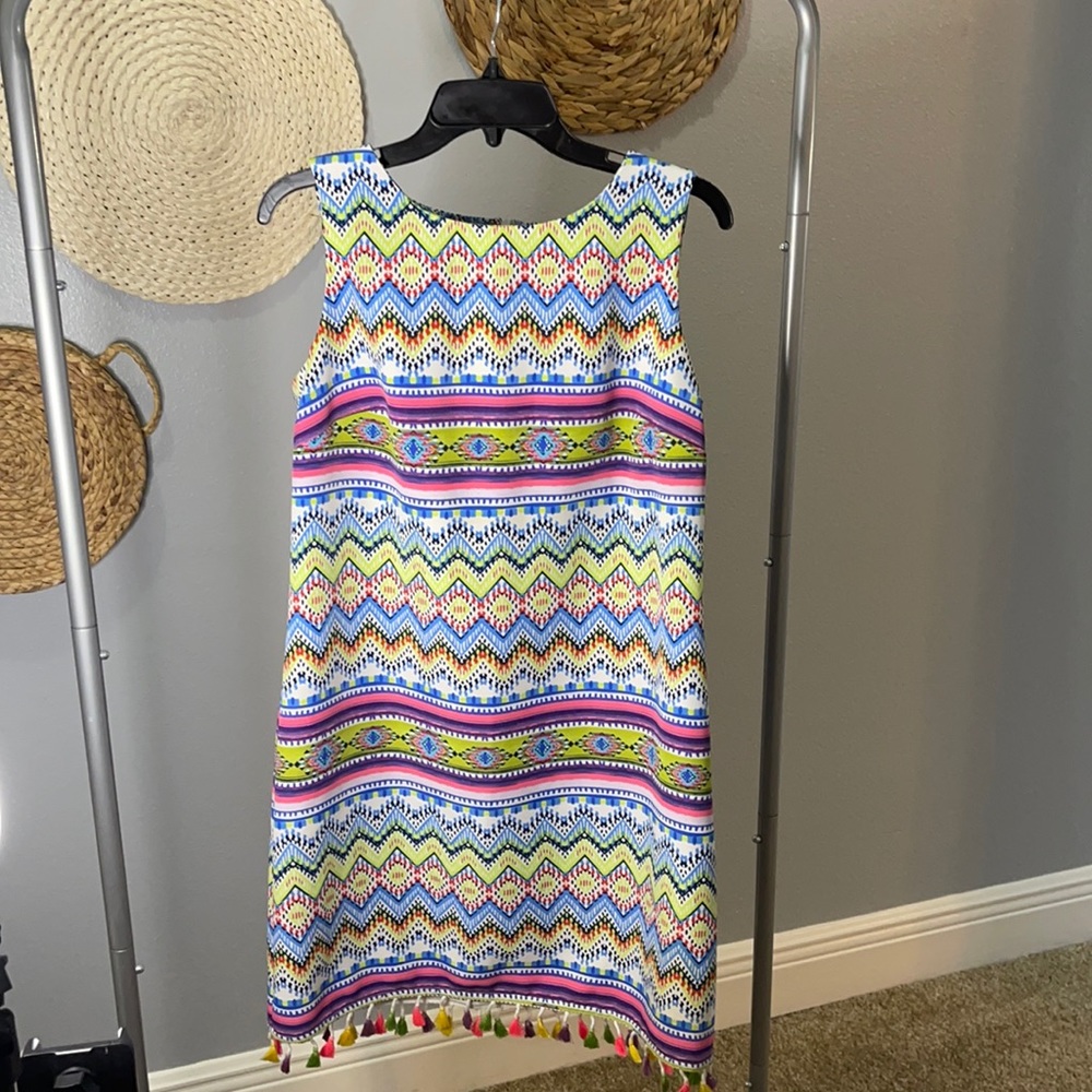 Bright festive dress with tassels.